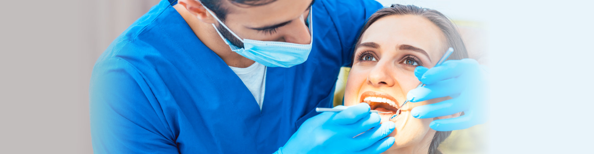 dentist during safe and painless dental treatment in a modern clinic